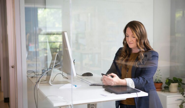 woman in black leather jacket using macbook air